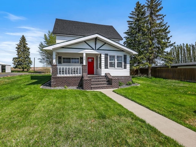 610 Ross St, Davenport, WA 99122 - bungalow-style house featuring a porch, a front yard, roof with shingles, brick siding, and fence