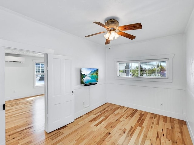 610 Ross St, Davenport, WA 99122 - empty room featuring a ceiling fan, a wall mounted AC, and light wood-style flooring