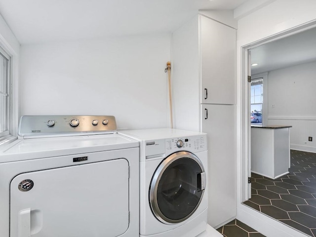 610 Ross St, Davenport, WA 99122 - laundry area with dark tile patterned flooring, a wainscoted wall, and washing machine and dryer