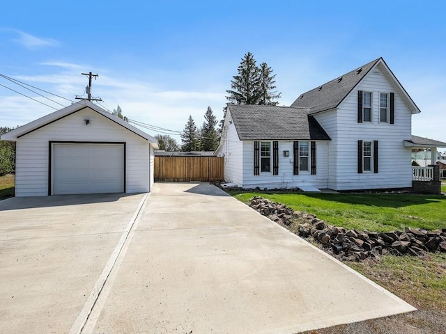 610 Ross St, Davenport, WA 99122 - traditional home with driveway, a front yard, a detached garage, fence, and an outdoor structure