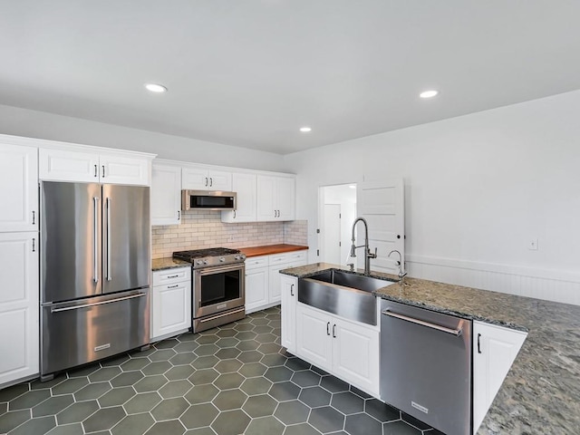 610 Ross St, Davenport, WA 99122 - kitchen featuring a sink, high end appliances, white cabinets, and tasteful backsplash