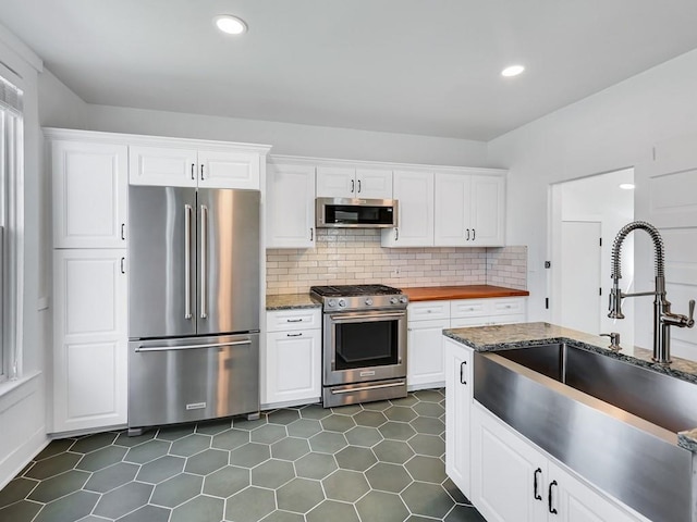 610 Ross St, Davenport, WA 99122 - kitchen with white cabinets, stainless steel appliances, and a sink
