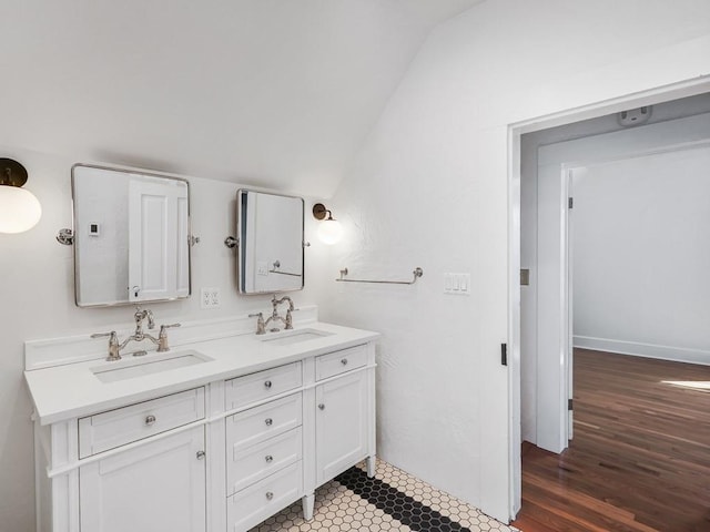 610 Ross St, Davenport, WA 99122 - bathroom featuring a sink, wood finished floors, double vanity, and lofted ceiling