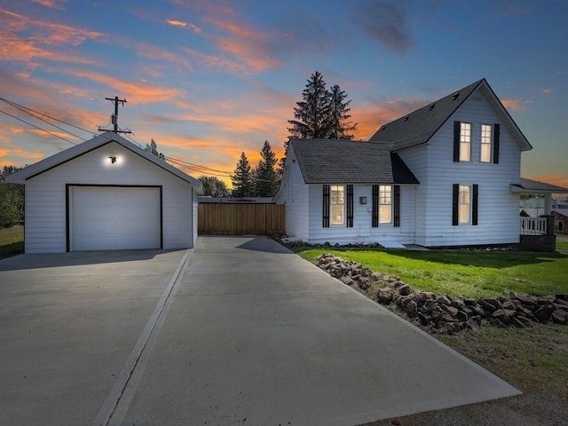 610 Ross St, Davenport, WA 99122 - view of front facade featuring fence, a garage, a front yard, an outdoor structure, and driveway