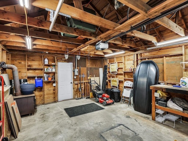 610 Ross St, Davenport, WA 99122 - garage with a workshop area, a garage door opener, and wood walls