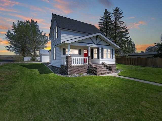 610 Ross St, Davenport, WA 99122 - view of front of property featuring fence, a detached garage, covered porch, and a front lawn
