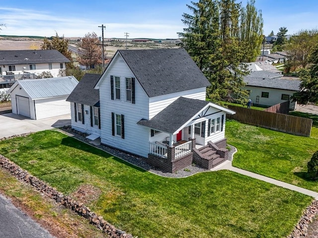 610 Ross St, Davenport, WA 99122 - traditional-style home featuring a porch, a garage, fence, an outdoor structure, and a shingled roof