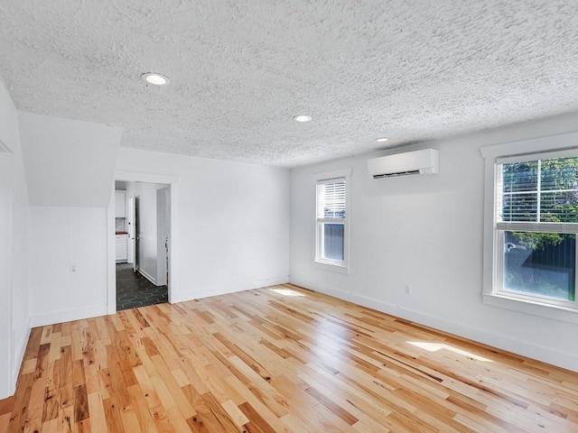 610 Ross St, Davenport, WA 99122 - spare room featuring recessed lighting, a textured ceiling, a wall mounted AC, and light wood-type flooring