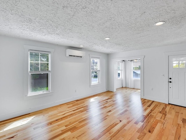 610 Ross St, Davenport, WA 99122 - interior space featuring recessed lighting, a textured ceiling, a wall unit AC, and hardwood / wood-style flooring