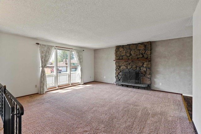 1317 S Woodlawn Rd, Spokane Valley, WA 99216 - unfurnished living room with a stone fireplace, carpet flooring, and a textured ceiling