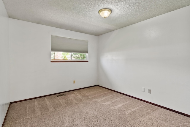 1317 S Woodlawn Rd, Spokane Valley, WA 99216 - carpeted spare room with visible vents, a textured ceiling, and baseboards