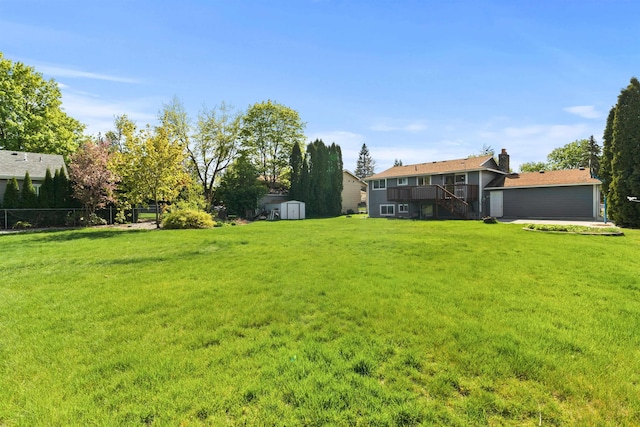 1317 S Woodlawn Rd, Spokane Valley, WA 99216 - view of yard featuring a deck, fence, an outdoor structure, a storage unit, and stairs