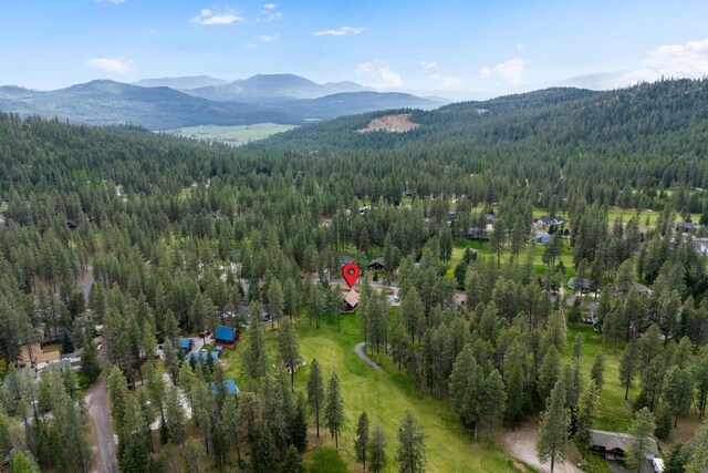 birds eye view of property featuring a mountain view and a forest view