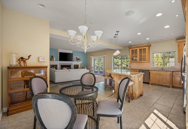 1909 E Pinecrest Rd, Spokane, WA 99203 - dining area featuring recessed lighting, plenty of natural light, a chandelier, a lit fireplace, and light tile patterned floors