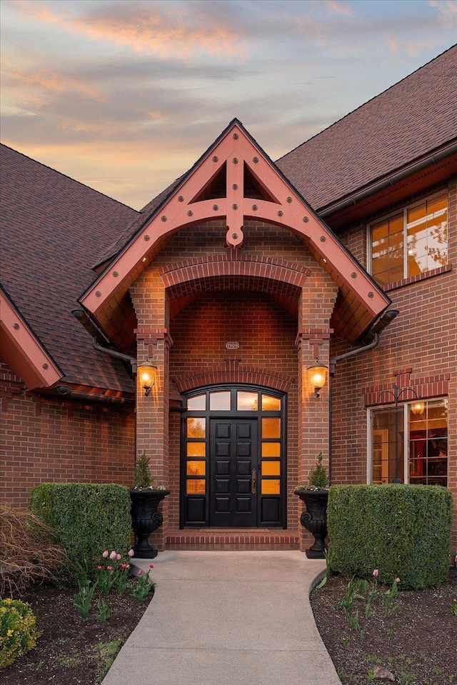 1909 E Pinecrest Rd, Spokane, WA 99203 - exterior entry at dusk featuring brick siding and a shingled roof