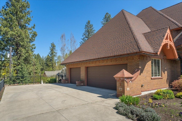 1909 E Pinecrest Rd, Spokane, WA 99203 - view of home's exterior featuring brick siding, a garage, and a shingled roof
