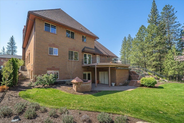 1909 E Pinecrest Rd, Spokane, WA 99203 - back of house featuring brick siding, stairs, a lawn, a wooden deck, and a patio area