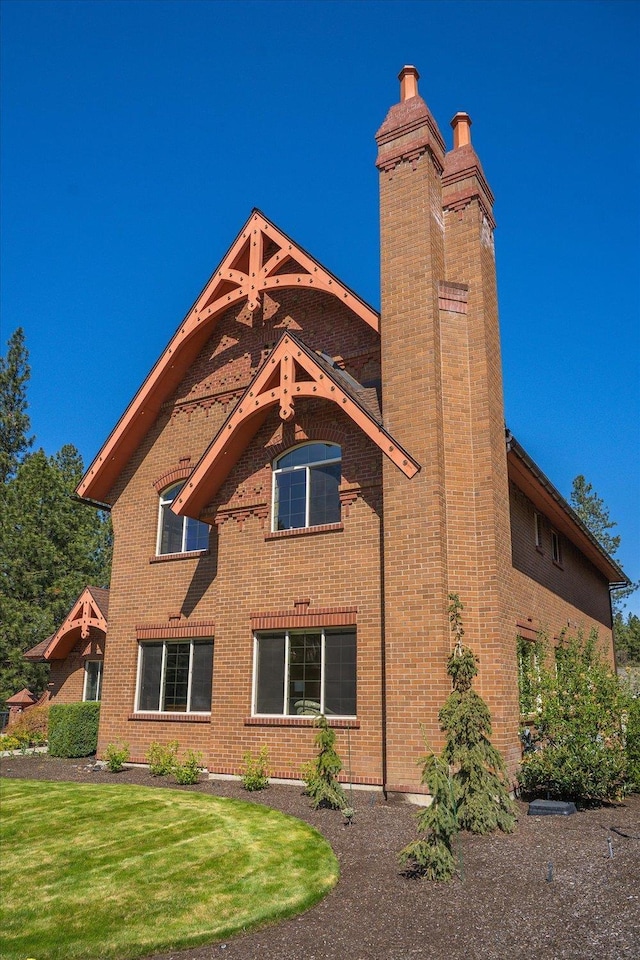 1909 E Pinecrest Rd, Spokane, WA 99203 - rear view of property featuring a chimney, brick siding, and a lawn