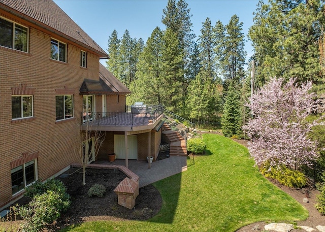 1909 E Pinecrest Rd, Spokane, WA 99203 - view of green lawn featuring stairway, a wooden deck, and a patio