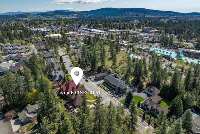 1909 E Pinecrest Rd, Spokane, WA 99203 - aerial view of property's location with a mountain backdrop, nearby suburban area, and a forest