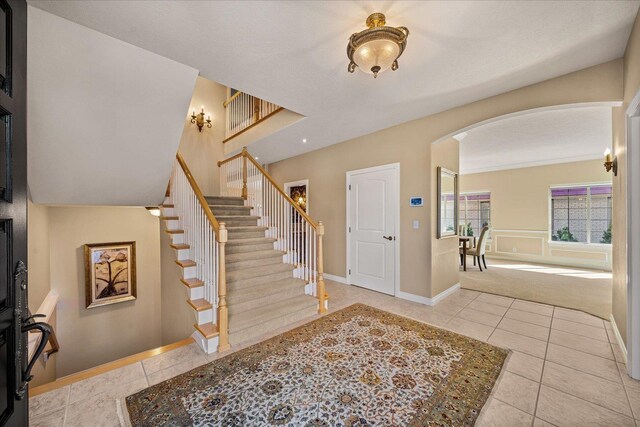 1909 E Pinecrest Rd, Spokane, WA 99203 - tiled entrance foyer featuring arched walkways, stairway, and baseboards