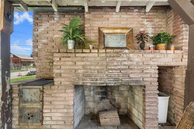 details with brick siding and an outdoor brick fireplace