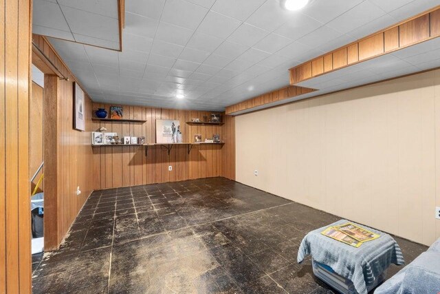 finished below grade area featuring wood walls