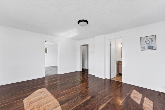5804 N Regal St, Spokane, WA 99208 - unfurnished living room with baseboards, a textured ceiling, and wood finished floors