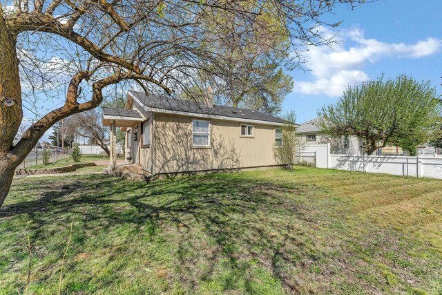 5804 N Regal St, Spokane, WA 99208 - view of home's exterior featuring fence and a lawn