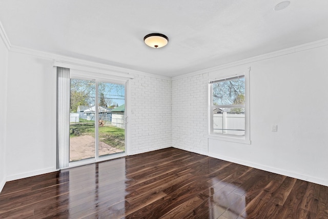 5804 N Regal St, Spokane, WA 99208 - empty room featuring crown molding, plenty of natural light, dark wood finished floors, and brick wall