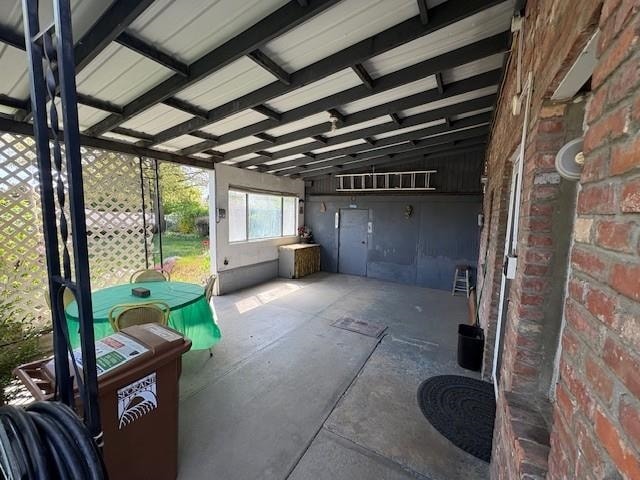 unfurnished sunroom featuring beam ceiling