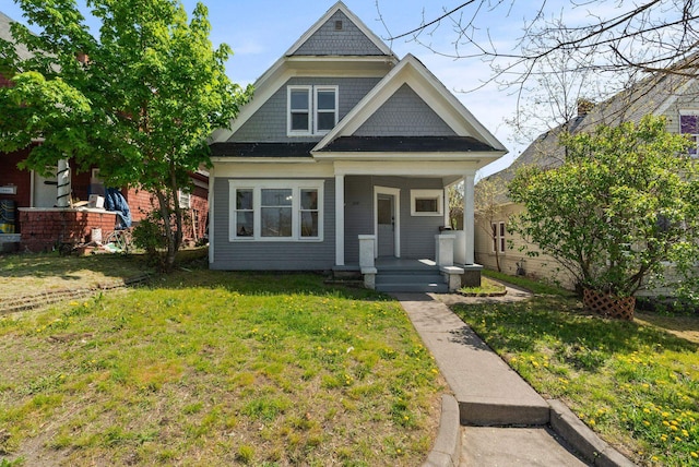 view of front of house with a porch and a front lawn