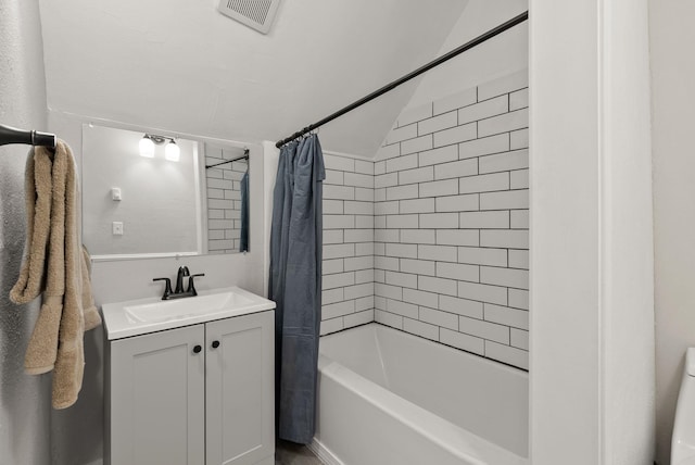 bathroom with vanity, shower / bath combo, and visible vents
