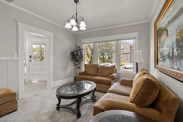 carpeted living room featuring crown molding and a notable chandelier