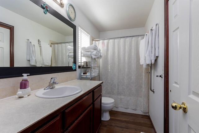 bathroom featuring vanity, shower / bath combo with shower curtain, wood finished floors, toilet, and backsplash
