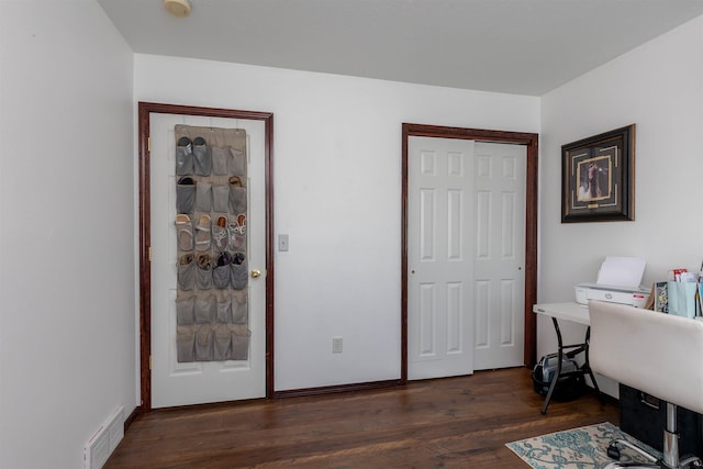 office area featuring visible vents and dark wood-type flooring