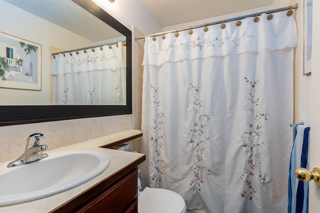 bathroom with vanity, toilet, and curtained shower