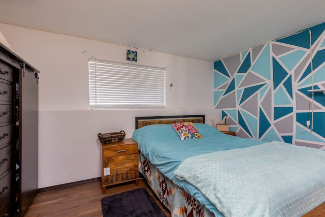 bedroom with baseboards and wood finished floors