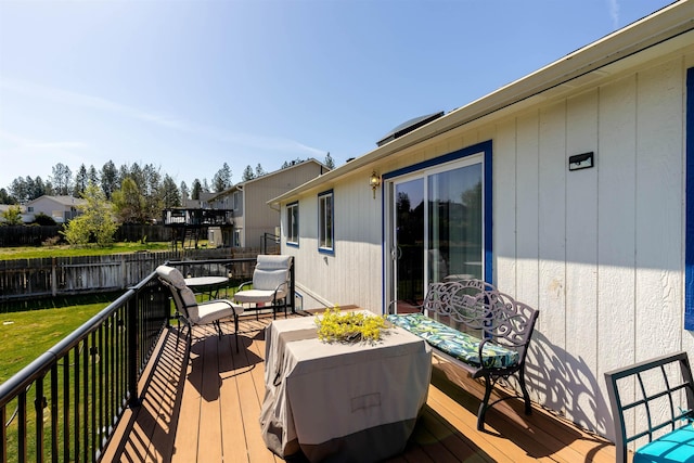 wooden deck featuring fence and a yard