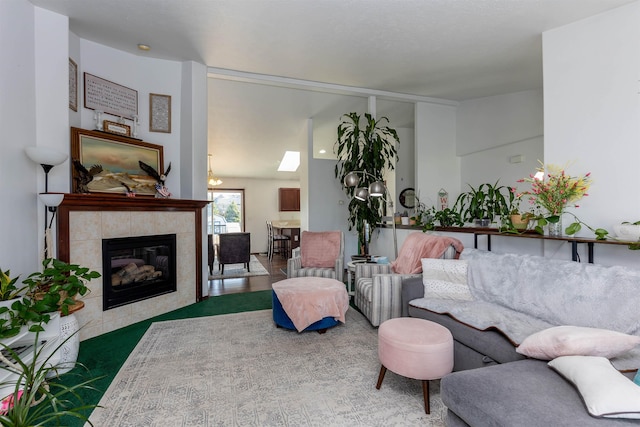 living area featuring a tile fireplace