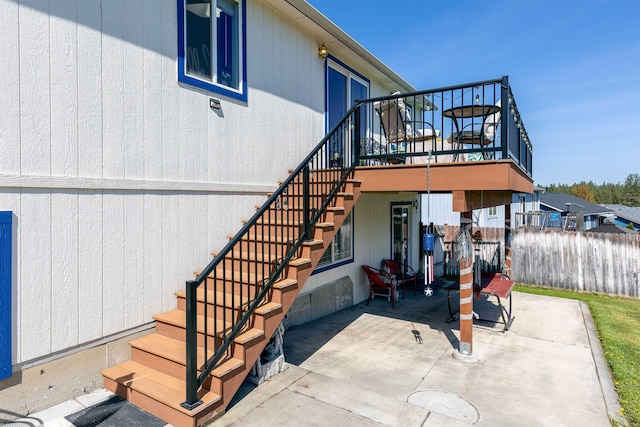 exterior space with stairs, fence, and a deck