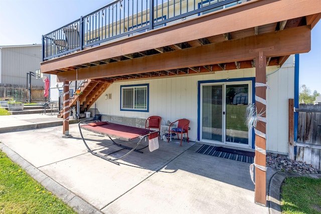view of patio / terrace with stairs and fence