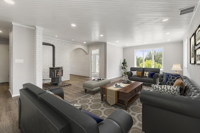 572 Smiley Ln, Newport, WA 99156 - living area with baseboards, a wood stove, wood finished floors, and visible vents