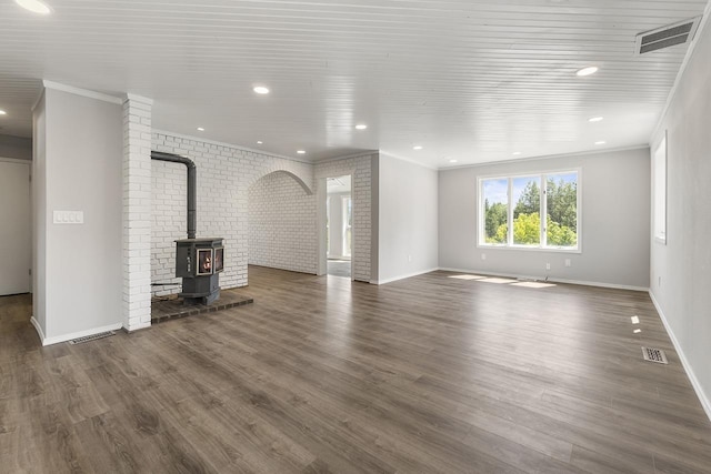 572 Smiley Ln, Newport, WA 99156 - unfurnished living room featuring visible vents, baseboards, crown molding, and wood finished floors