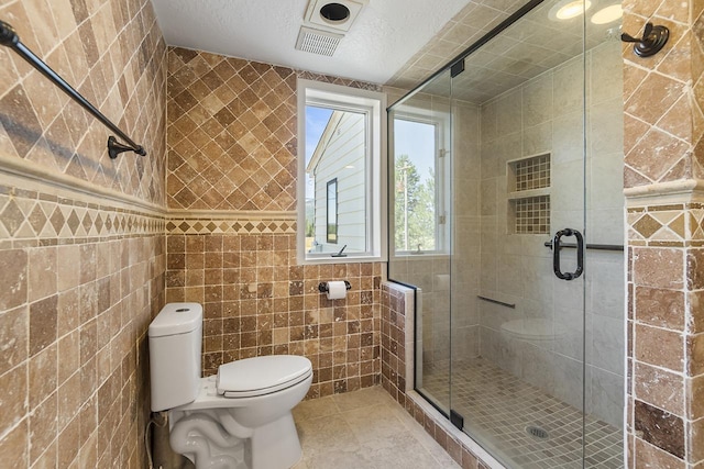 572 Smiley Ln, Newport, WA 99156 - full bathroom with toilet, tile walls, and a stall shower