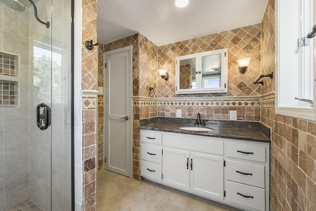 572 Smiley Ln, Newport, WA 99156 - full bath with vanity, tile patterned floors, tile walls, and a shower stall