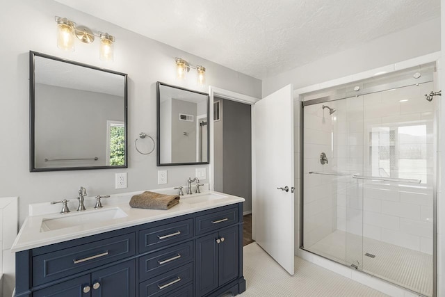 572 Smiley Ln, Newport, WA 99156 - full bathroom featuring double vanity, a sink, and a stall shower