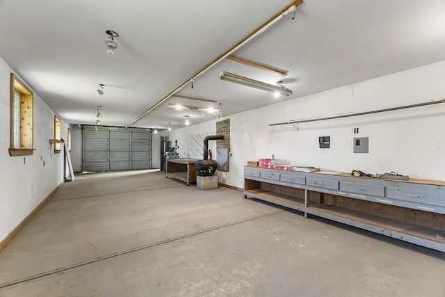 572 Smiley Ln, Newport, WA 99156 - garage with baseboards, a workshop area, and electric panel