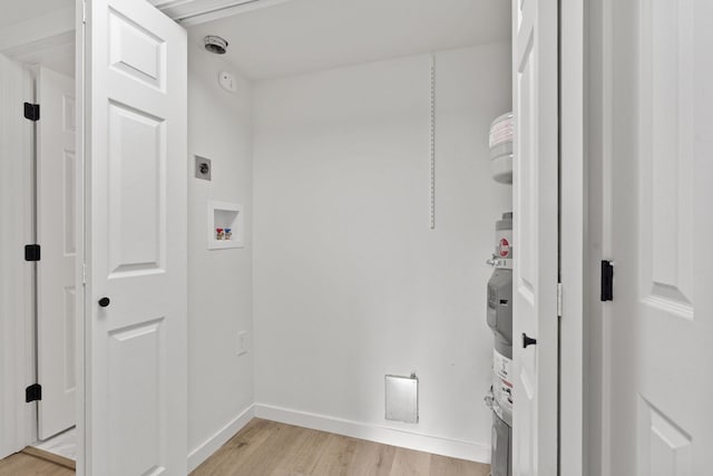 1111 W 6th Ave # 205, Spokane, WA 99204 - laundry area with light wood-type flooring, baseboards, hookup for an electric dryer, and washer hookup