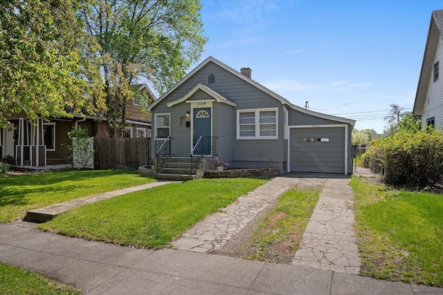 bungalow-style house featuring fence, a chimney, driveway, and a front yard